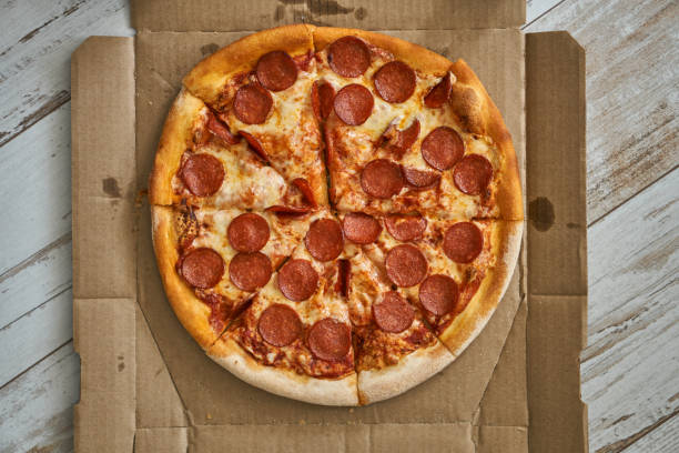 istock Pizza assorted pepperoni in box and on white plate. Hot with cheese and seafood. 1304168081