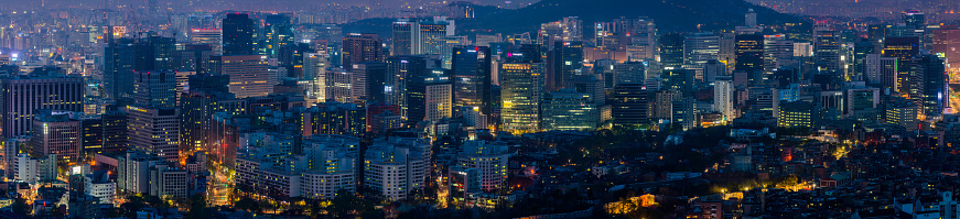 Aerial panorama over the illuminated night cityscape of central Seoul, South Korea’s vibrant capital city.