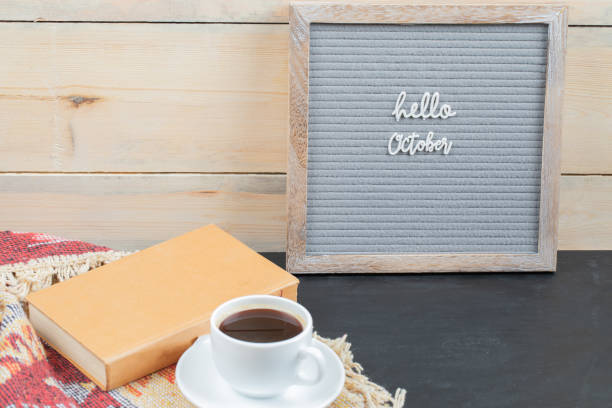 istock Hello octiber phrase embedded on grey background with a cup of coffee around 1304169399
