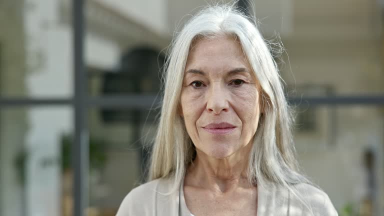 Outdoor Portrait of Mid 60s Woman with Long Gray Hair