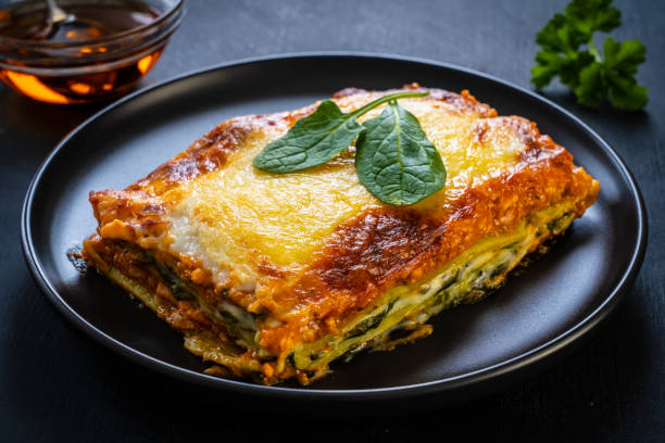 istock Lasagna with pork and spinach on black table 1304171726