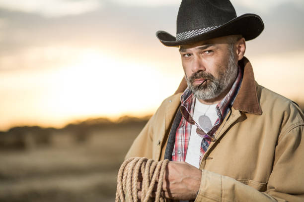 istock Farmer on the field wearing hat and work clothes 1304171812