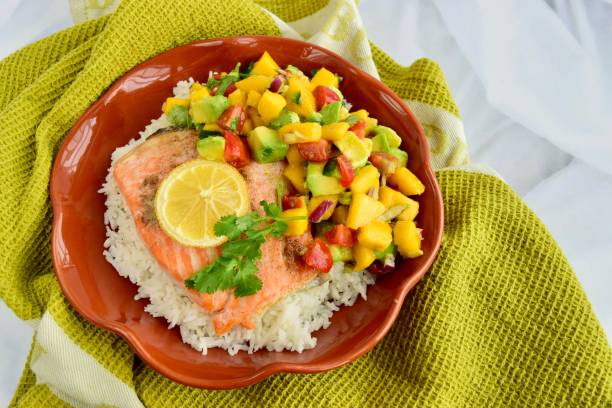 istock Baked salmon with coconut rice and mango avocado salsa 1304171940