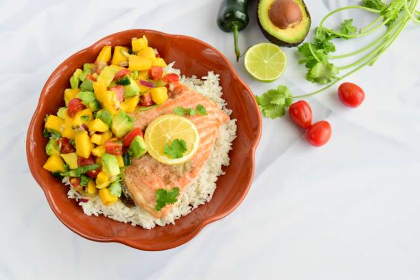 istock Baked salmon with coconut rice and mango avocado salsa 1304171943