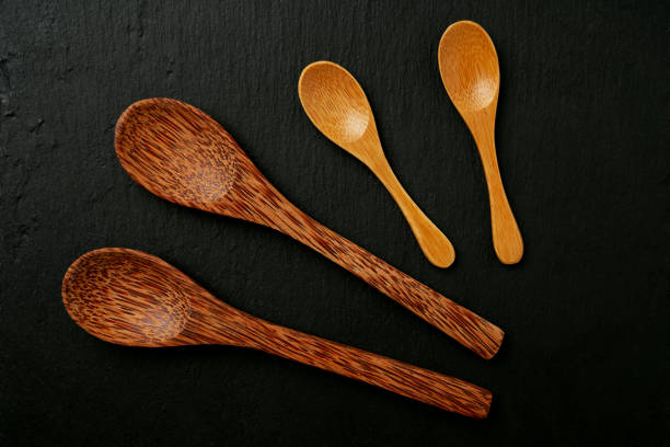 istock Sustainable kitchenware, bamboo spoons isolated on slate bard. Sustainability zero waste concept. Flat Lay. Top View 1304172196
