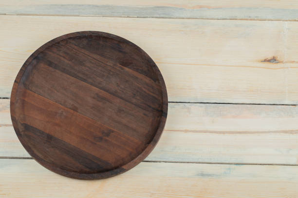 istock Rustic round wooden platter carved from oak tree 1304172988