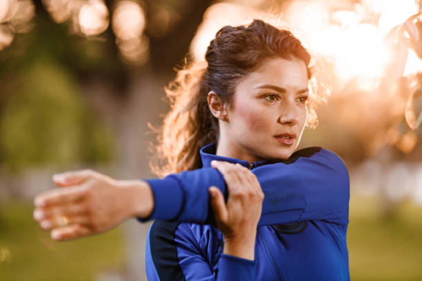 istock Athletic woman stretching her arm in the park. 1304173317