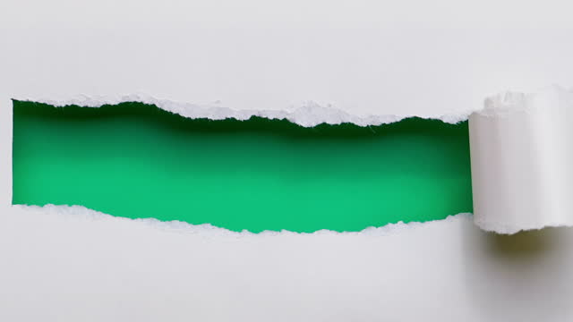 4k : stop motion of paper is torn over green background for message