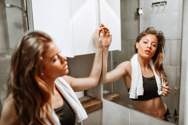 istock Beautiful Female And Her Reflection In Mirror After Tough Workout 1304175552