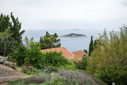 Afionas, Corfu, Greece: Footpath through Afionas, a colorfully planted little mountain village near the Porto Timoni beach.