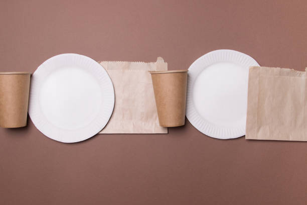istock infinity line of eco-friendly kitchen ware on brown colored papet background. top view. close-up. recycle 1304176762