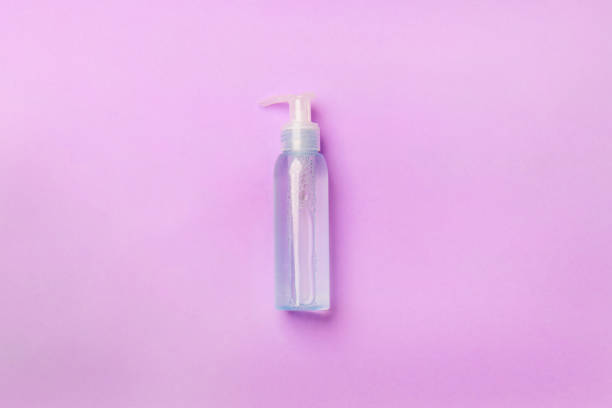 istock blue cosmetic bottle with liquid lying on purple background 1304176795