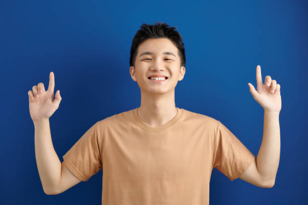 istock Handsome man over isolated blue wall surprised and pointing up 1304181177