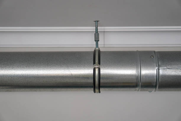 istock Grey stainless steel pipe in the kitchen near the white ceiling. Range hood. 1304182108