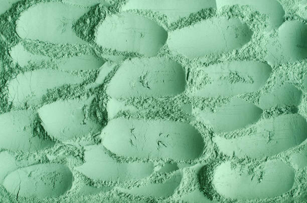 istock Green cosmetic clay powder (kelp facial mask, spirulina body wrap) texture close up, selective focus. Abstract background. 1304182318