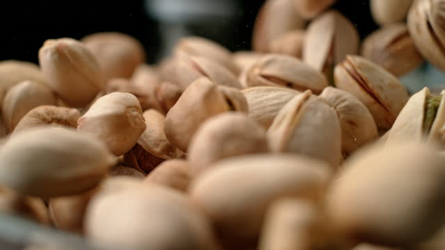SLO MO LD Pistachio nuts falling and piling up