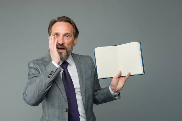 istock businessman surprised by interesting information in book. get ready for business training. successful man in business suit hold notebook. planning and success concept. feel the surprise 1304185477