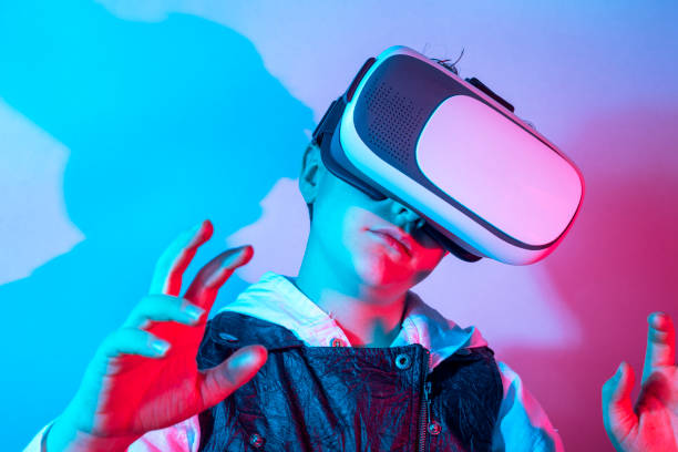 istock Amazed child touching the air during the VR experience. Horizontal studio shot. 1304186856