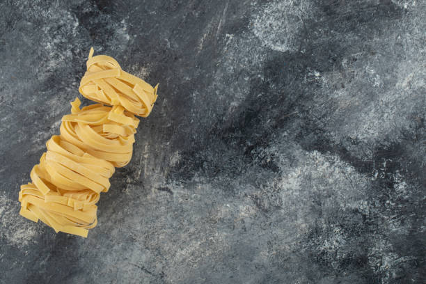 Raw dry nest noodles on a marble background