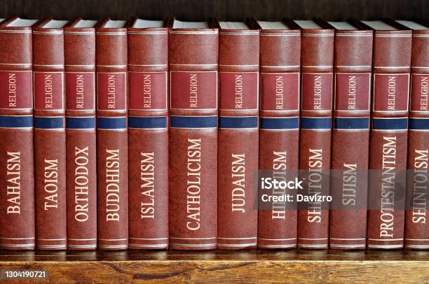 Collection Of Books Of Various Religions On A Wooden Shelf Stock Photo - Download Image Now