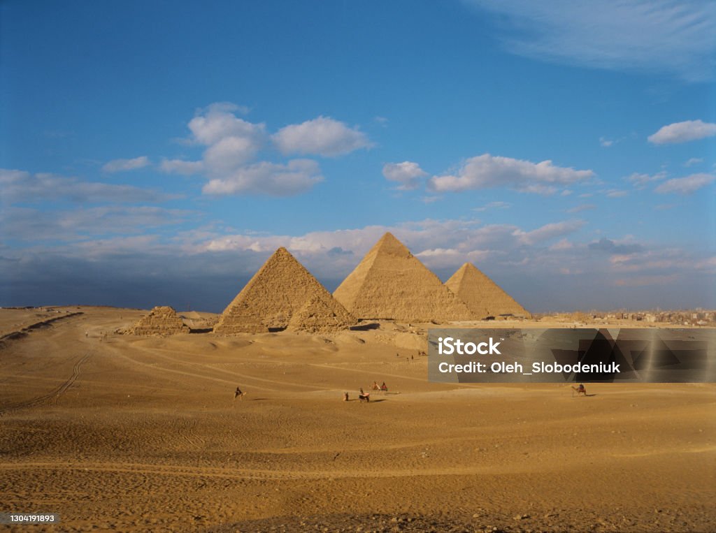 Scenic view of Giza pyramids at sunset Scenic view of Giza pyramids at sunset. Medium format camera Pyramid Stock Photo