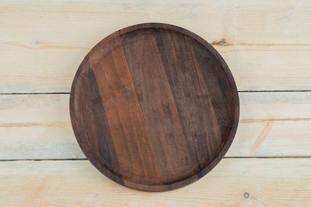 istock Round wooden platter carved from oak tree 1304192072