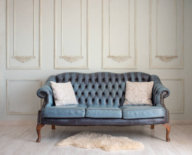 istock Beautiful vintage sofa on vintage wall background. 1304194380