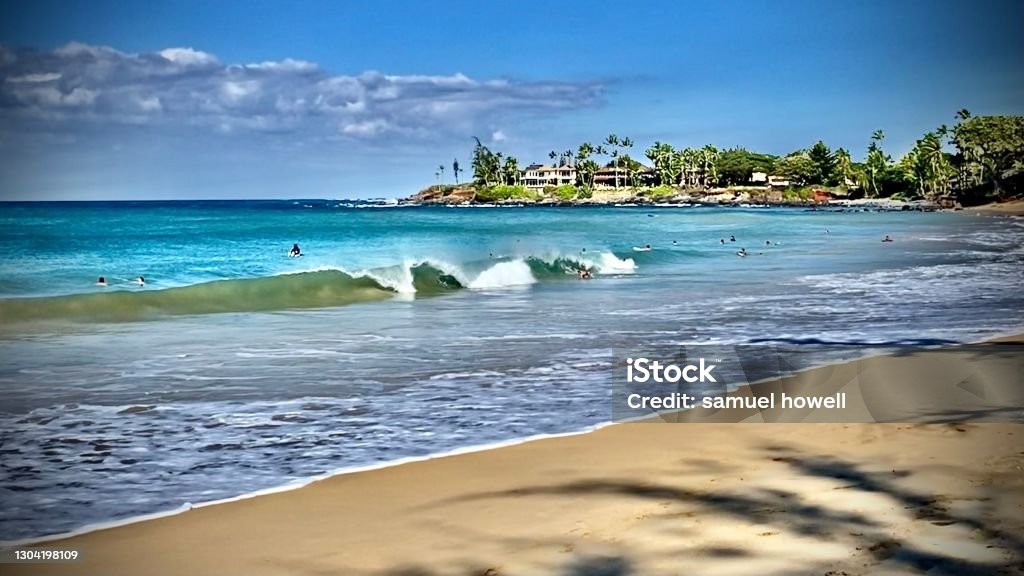 crashing waves and surfers at the beach on a beach on maui, hi - usa Surfing Event Stock Photo
