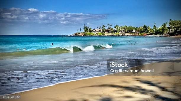 Crashing Waves And Surfers At The Beach Stock Photo - Download Image Now - Surfing Event, Maui, Breaking Wave