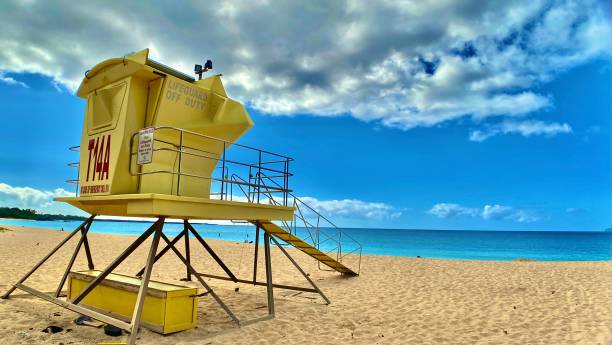 istock one yellow lifeguard stand with blue skies and dramatic clouds 1304198157
