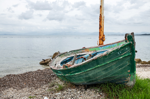 Corfu, Greece: An abandoned fishing boats at the coast near the harbor of Petriti.