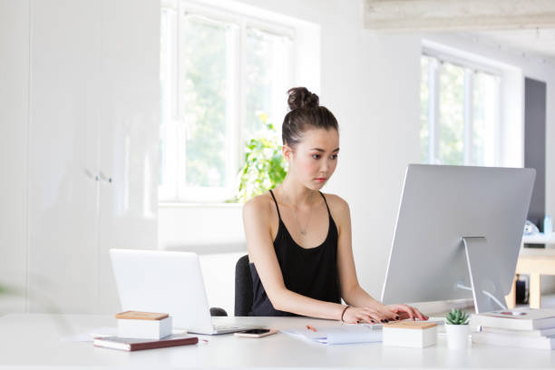 istock Young woman working on computer in the eco-friendly office 1304199041