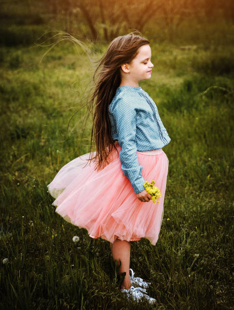 istock Little girl posing in the dark meadow. 1304199417