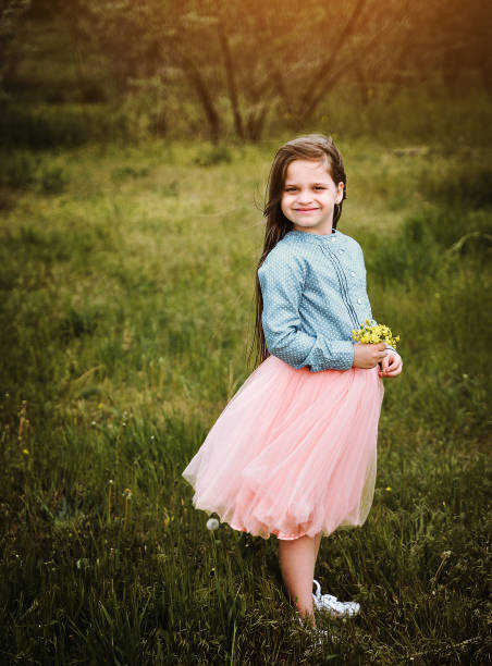 istock Little girl posing in the dark meadow. 1304199440