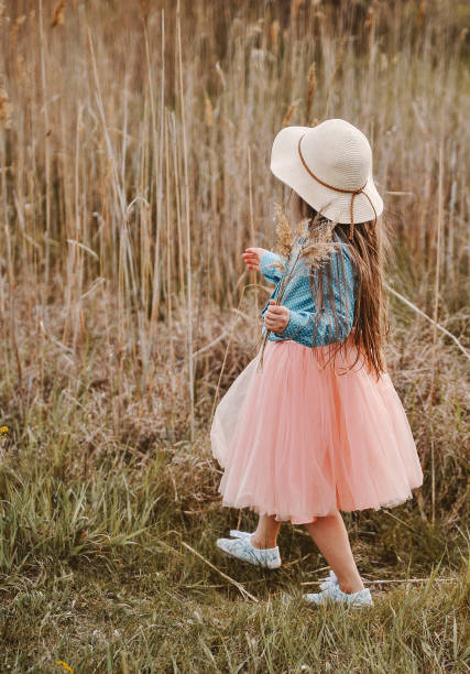 istock Little girl posing in the dark meadow. 1304199475