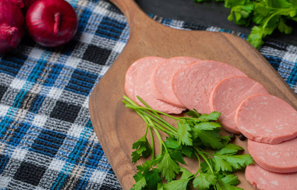 istock Fresh salami slices on wooden cutting board 1304200098