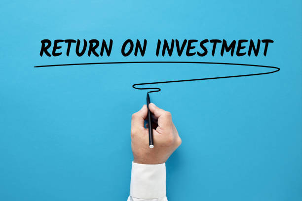 Businessman hand writing return on investment
