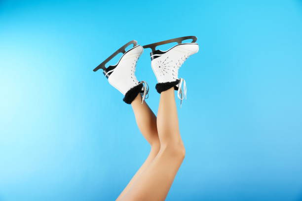 istock legs wearing ice skates raised up on blue background 1304201473