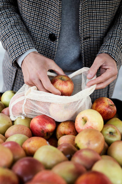 istock man uses a reusable mesh bag at the greengrocer 1304204338