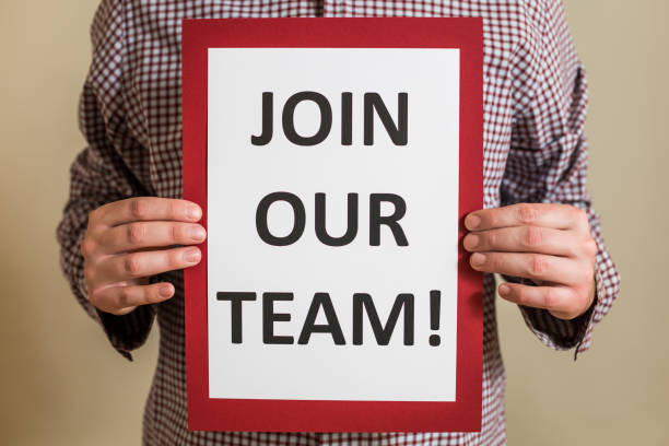 istock Man holding paper with text join our team 1304205604