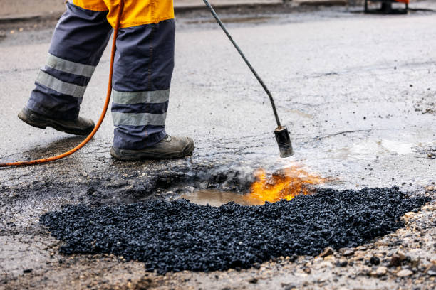 istock worker repairing pothole with bitumen asphalt on the road 1304206418