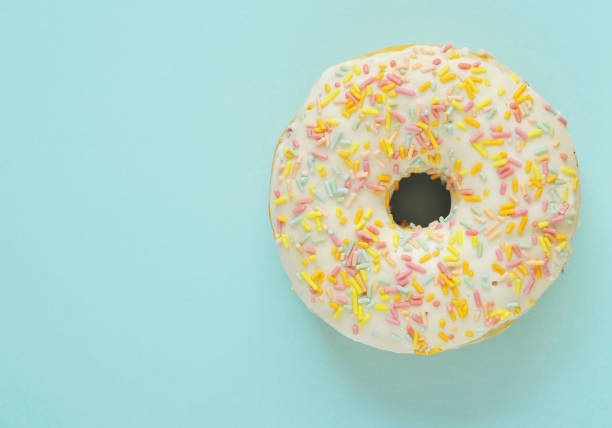 istock Delicious donuts on light pastel color background. 1304207716