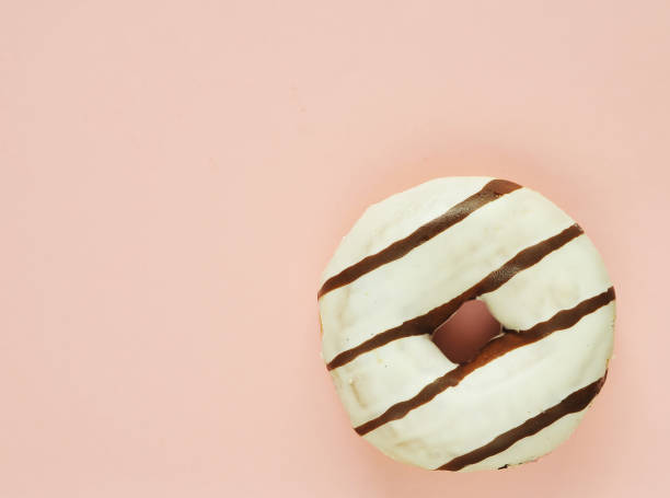 istock Delicious donuts on light pastel color background. 1304208040