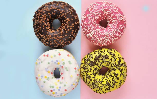 istock Delicious donuts on light pastel color background. 1304208101