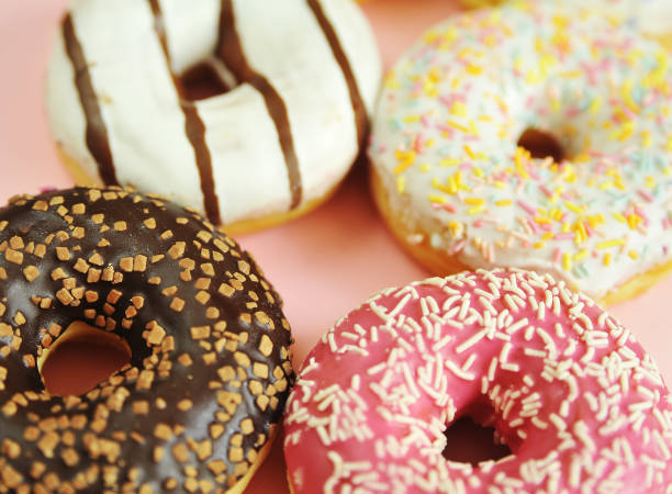 istock Delicious donuts on light pastel color background. 1304208191