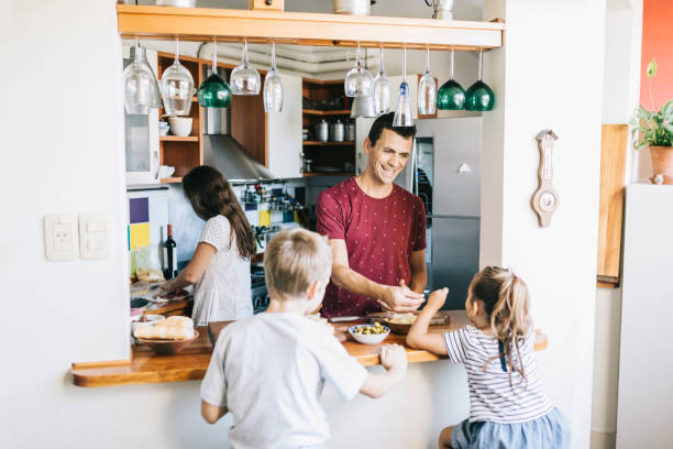istock Family preparing lunch in the kitchen 1304209349