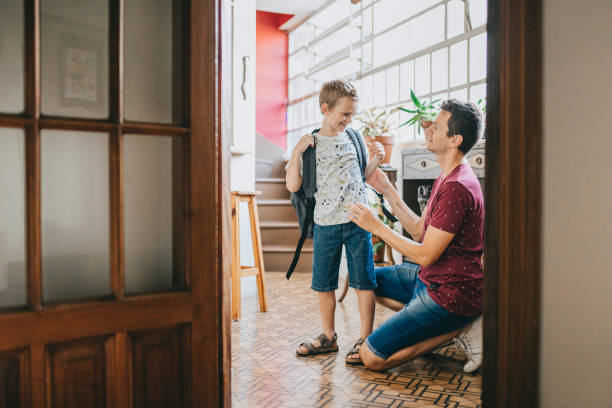istock Father sending son to school 1304209448