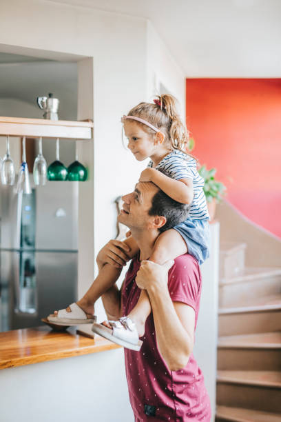 istock Father carrying daughter on  his shoulder 1304209481