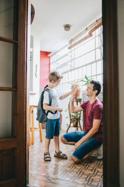istock Father welcoming son after school 1304209484