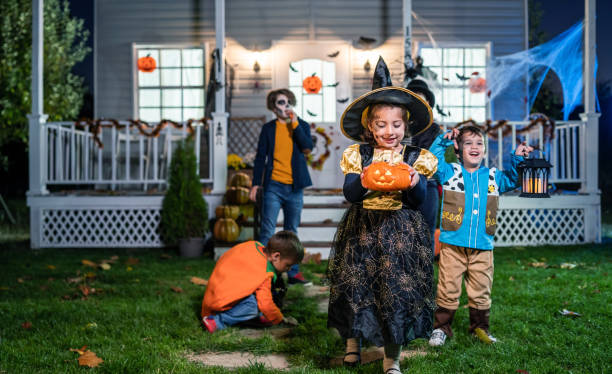 istock Young kids trick or treating at night during Halloween 1304209701